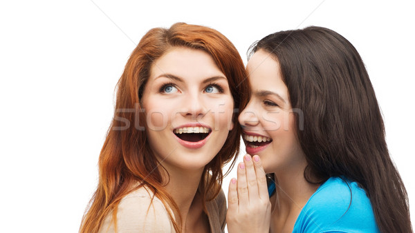 Stock photo: one girl telling another secret