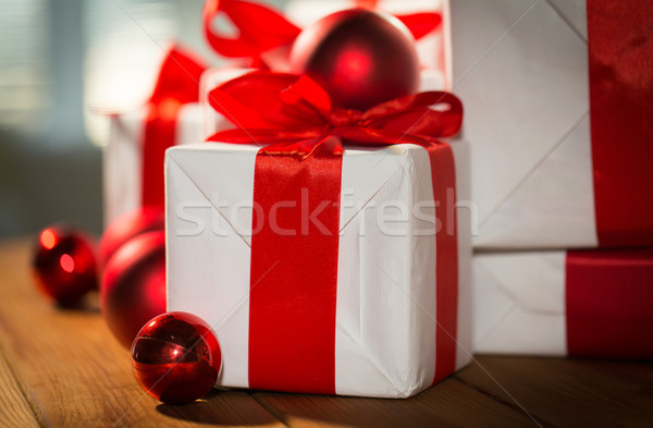 close up of gift boxes and red christmas balls Stock photo © dolgachov