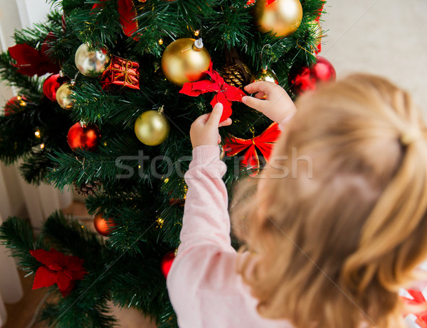 Stock photo: close up of child decorating christmas tree