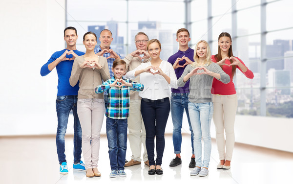 group of smiling people showing heart hand sign Stock photo © dolgachov