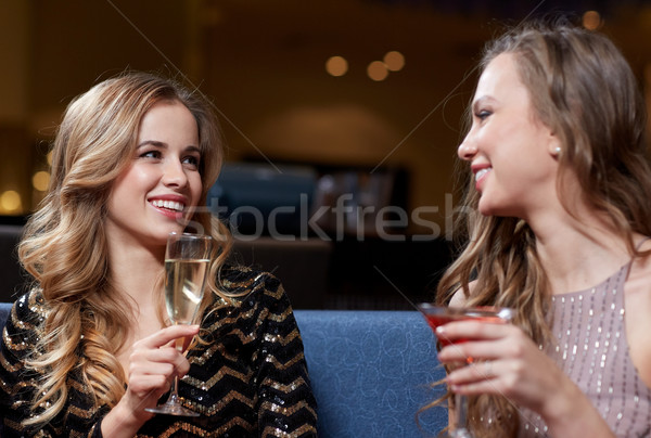 happy women with drinks at night club Stock photo © dolgachov
