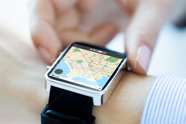 close up of hands with map on smartwatch screen Stock photo © dolgachov