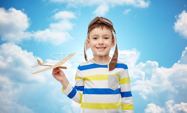 happy little boy in aviator hat with airplane Stock photo © dolgachov