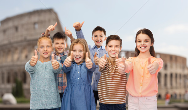 children showing thumbs up over coliseum in rome Stock photo © dolgachov