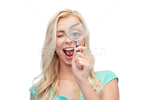 happy young woman with magnifying glass Stock photo © dolgachov