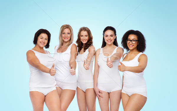 Stock photo: group of happy different women showing thumbs up