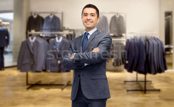 happy businessman in suit over clothing store Stock photo © dolgachov