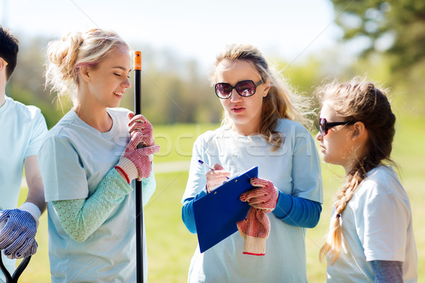 Stock photo: group of volunteers planting trees in park