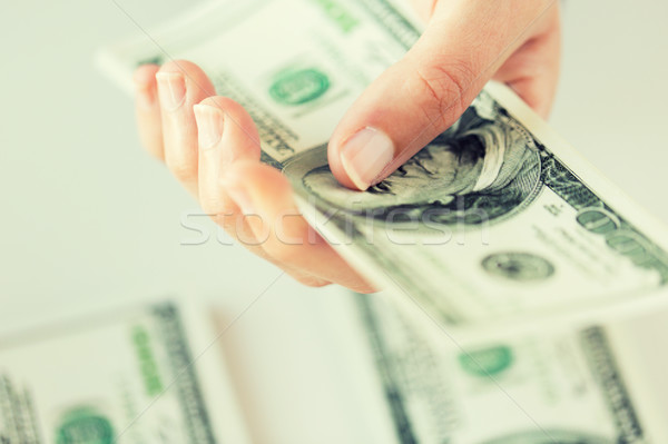 close up of woman hand counting us dollar money Stock photo © dolgachov