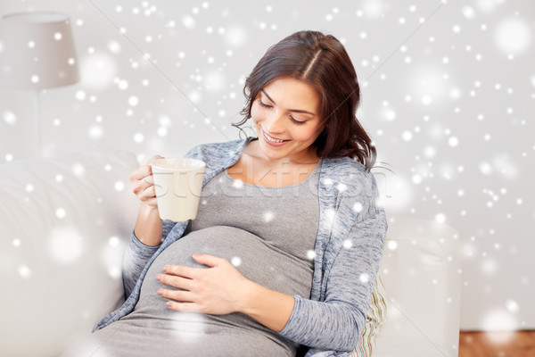 happy pregnant woman with cup drinking tea at home Stock photo © dolgachov