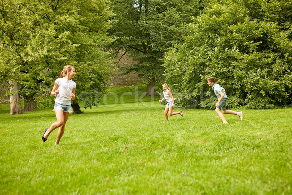 happy kids running and playing game outdoors Stock photo © dolgachov