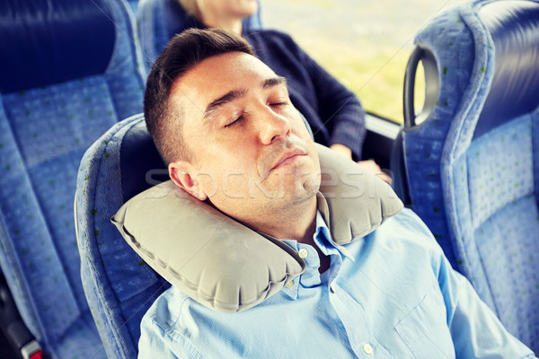 man sleeping in travel bus with cervical pillow Stock photo © dolgachov
