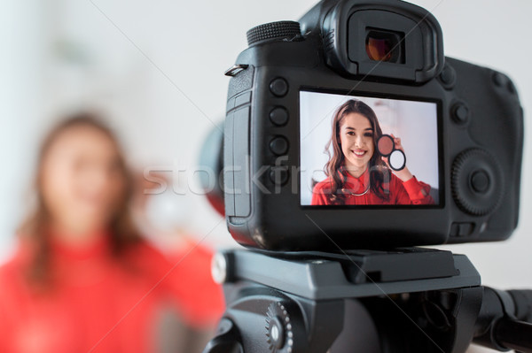 woman with bronzer and camera recording video Stock photo © dolgachov
