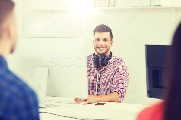 happy young man or student with computer at office Stock photo © dolgachov