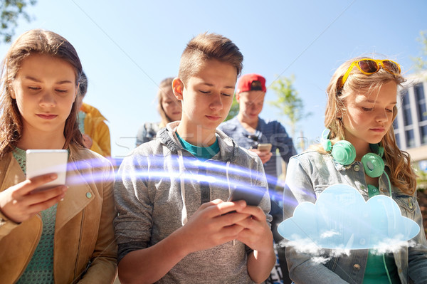 group of teenage friends with smartphones outdoors Stock photo © dolgachov