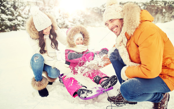 happy family with kid on sled having fun outdoors Stock photo © dolgachov