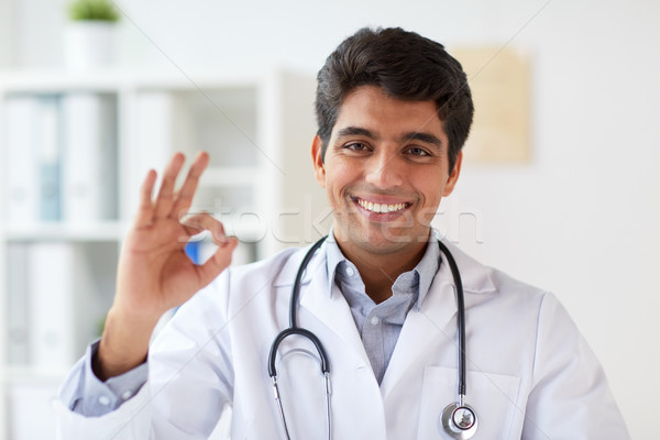 happy doctor with stethoscope at clinic showing ok Stock photo © dolgachov