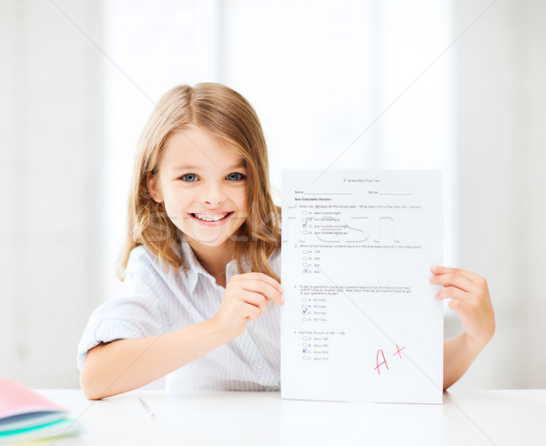 girl with test and A grade at school Stock photo © dolgachov