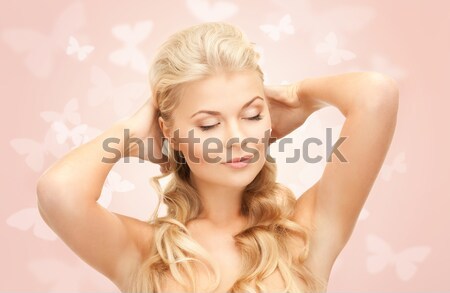 Stock photo: woman checking breast for signs of cancer