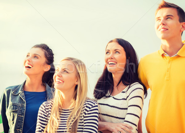 group of friends looking up on the beach Stock photo © dolgachov