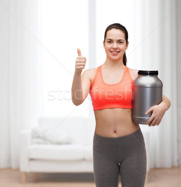 teenage girl with jar of protein showing thumbs up Stock photo © dolgachov