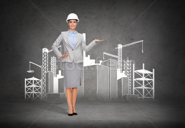 businesswoman in helmet showing construction site Stock photo © dolgachov