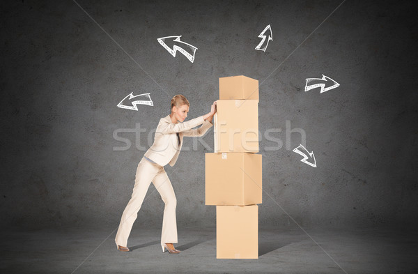 businesswoman pushing tower of cardboard boxes Stock photo © dolgachov