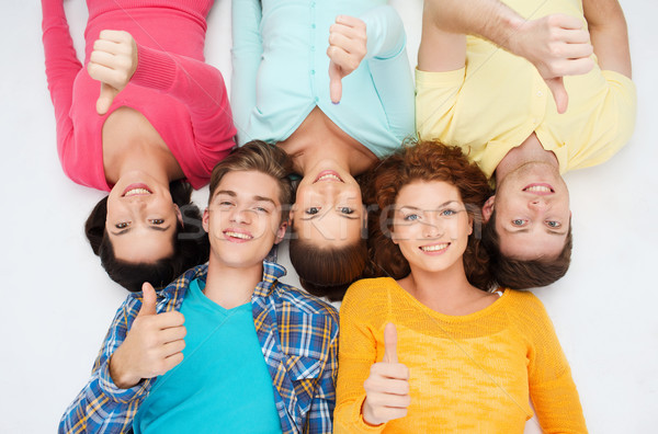 group of smiling teenagers showing thumbs up Stock photo © dolgachov