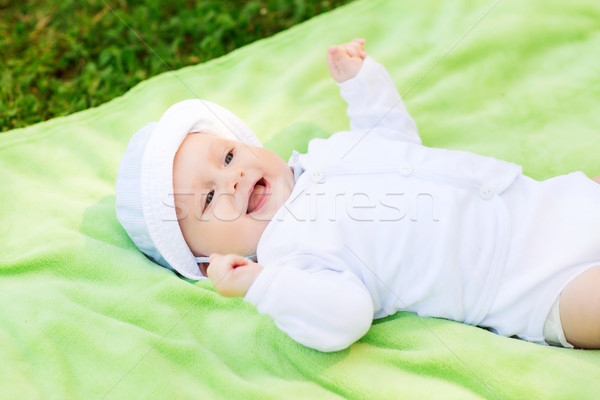 smiling baby lying on floor and looking up Stock photo © dolgachov