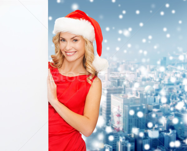 smiling young woman in santa hat with white board Stock photo © dolgachov