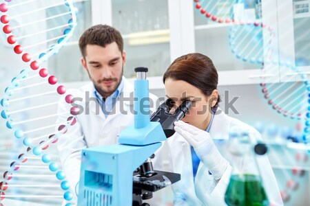 scientists with pipettes and test tubes in lab Stock photo © dolgachov