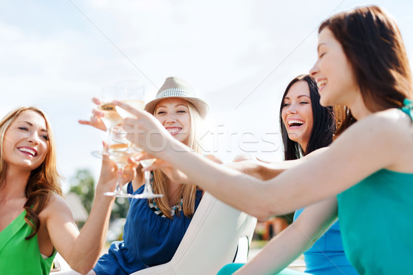 girls with champagne glasses on boat Stock photo © dolgachov