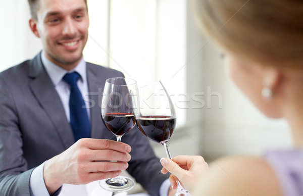 happy couple with glasses of wine at restaurant Stock photo © dolgachov