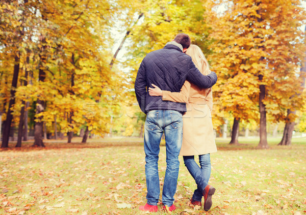 Stock photo: couple hugging in autumn park from back