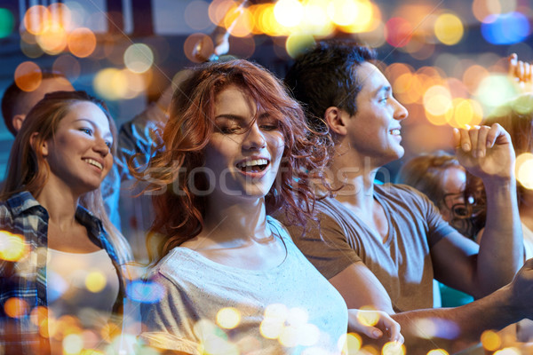 Stock photo: happy friends dancing at night club