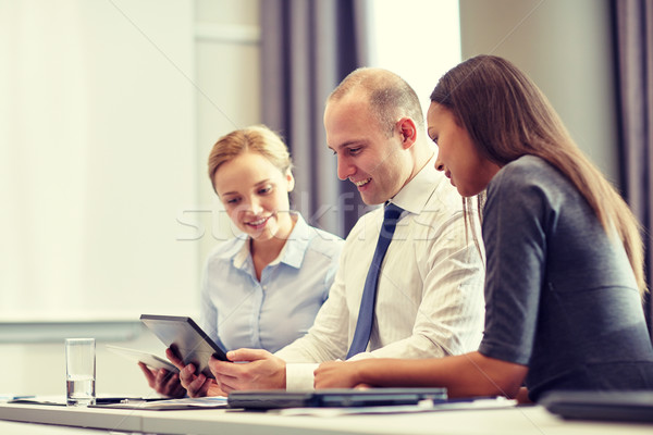 smiling business people with tablet pc in office Stock photo © dolgachov