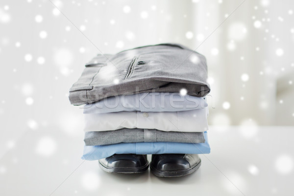close up of male shirts, pants and shoes on table Stock photo © dolgachov