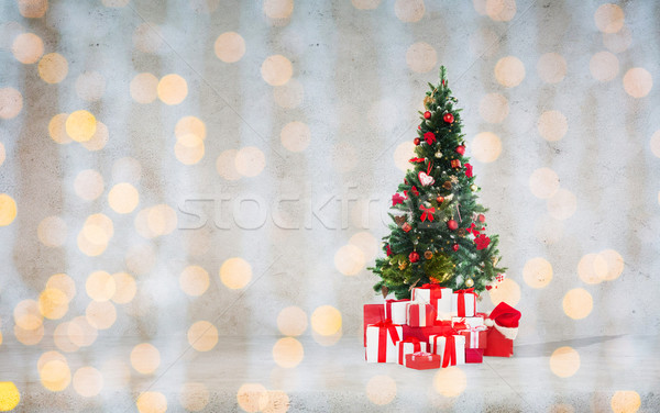 christmas tree with gifts over concrete wall Stock photo © dolgachov