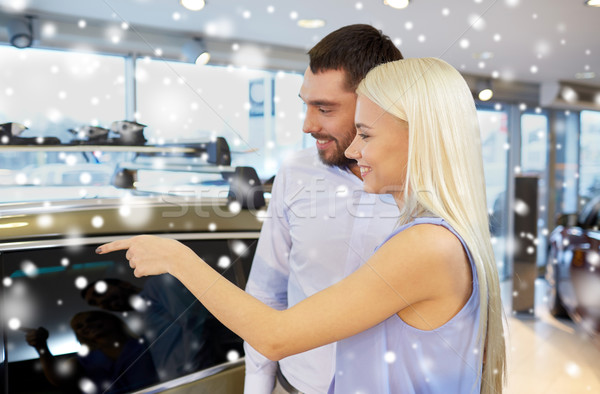 happy couple buying car in auto show or salon Stock photo © dolgachov