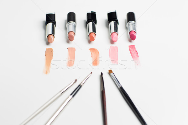 close up of lipsticks range with makeup brushes Stock photo © dolgachov