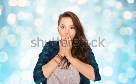 confused teenage girl covering her mouth by hand Stock photo © dolgachov