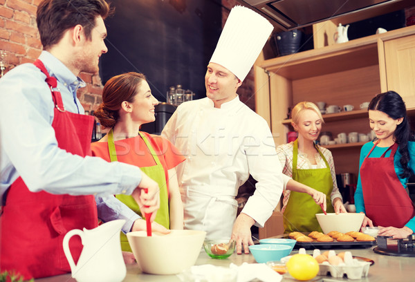 happy friends and chef cook baking in kitchen Stock photo © dolgachov