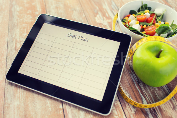 close up of diet plan on tablet pc and food Stock photo © dolgachov