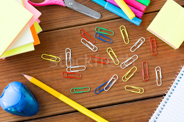 close up of clips, pens and stickers on wood Stock photo © dolgachov