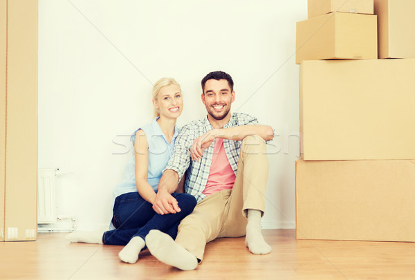 couple with cardboard boxes moving to new home Stock photo © dolgachov