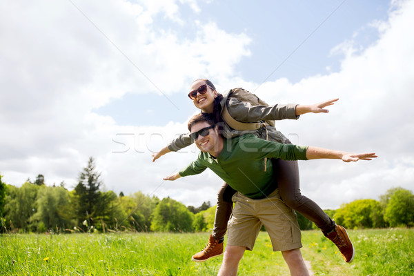 happy couple with backpacks having fun outdoors Stock photo © dolgachov