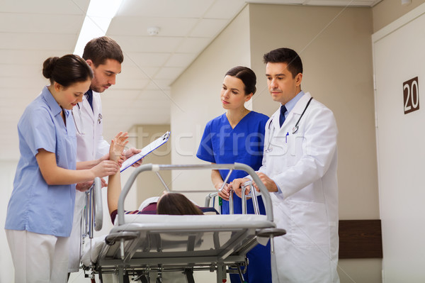 medics with woman on hospital gurney at emergency Stock photo © dolgachov