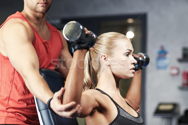 Homem mulher halteres ginásio esportes fitness Foto stock © dolgachov