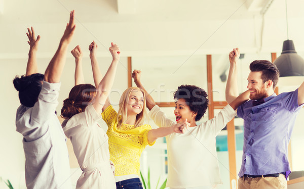 happy creative team celebrating victory in office Stock photo © dolgachov