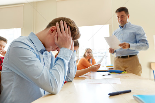 teacher giving test results to group of students Stock photo © dolgachov